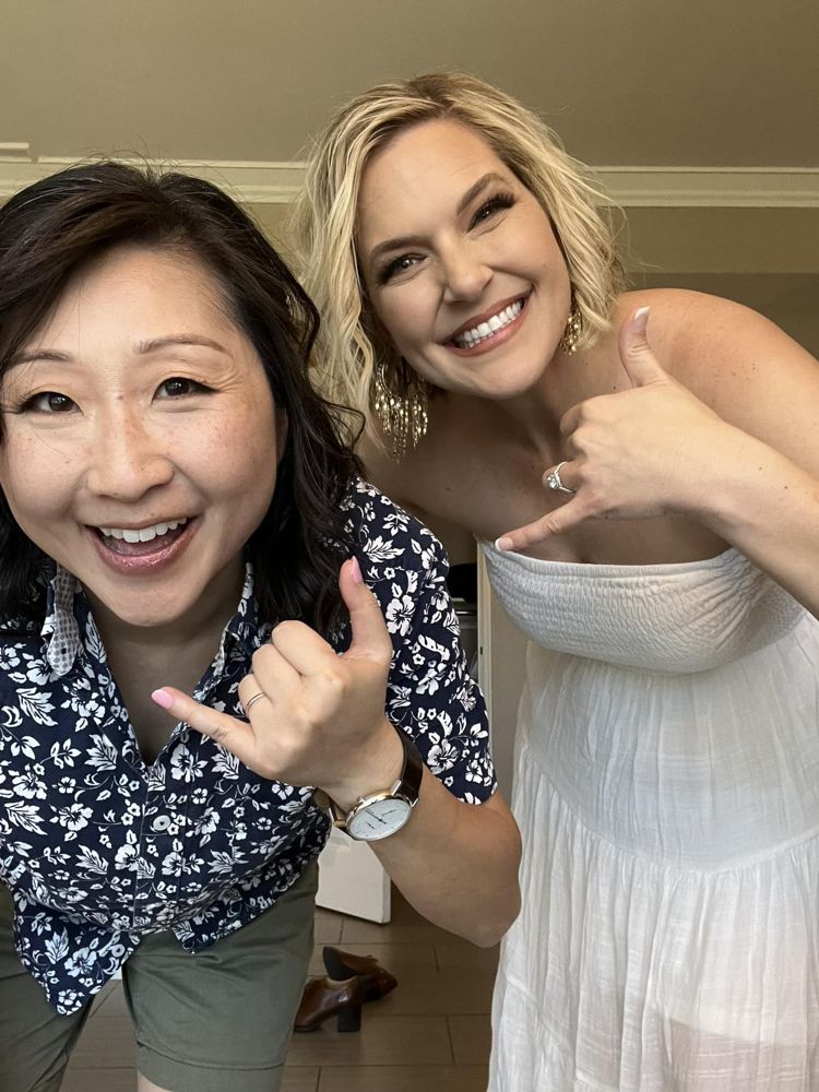 Annie and Sam smiling and throwing shaka signs