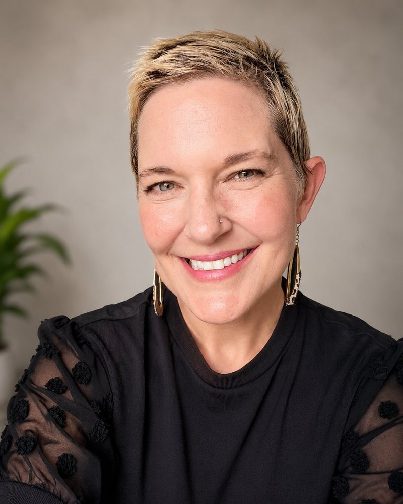 Headshot of Annie M. Henderson, Black Top, Neutral Background