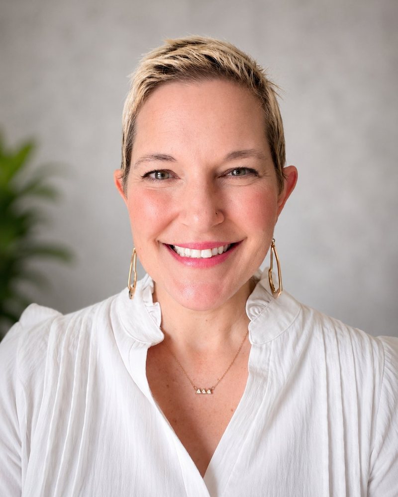 Headshot of Annie M. Henderson, White Top, Bright Smile