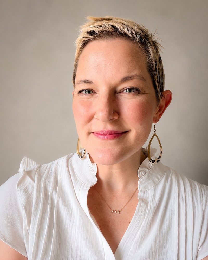 Headshot of Annie M. Henderson, White Top, Neutral Background